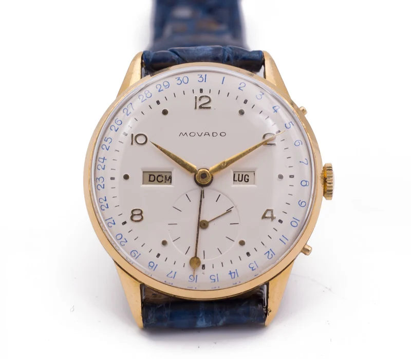 Montre vintage Movado avec calendrier complet, or 18 carats. 1950